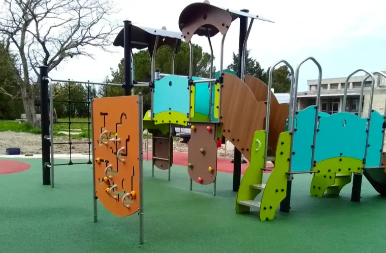 Aire de jeux extérieure avec sol souple et structures pour enfants